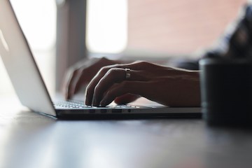 hands typing on computer